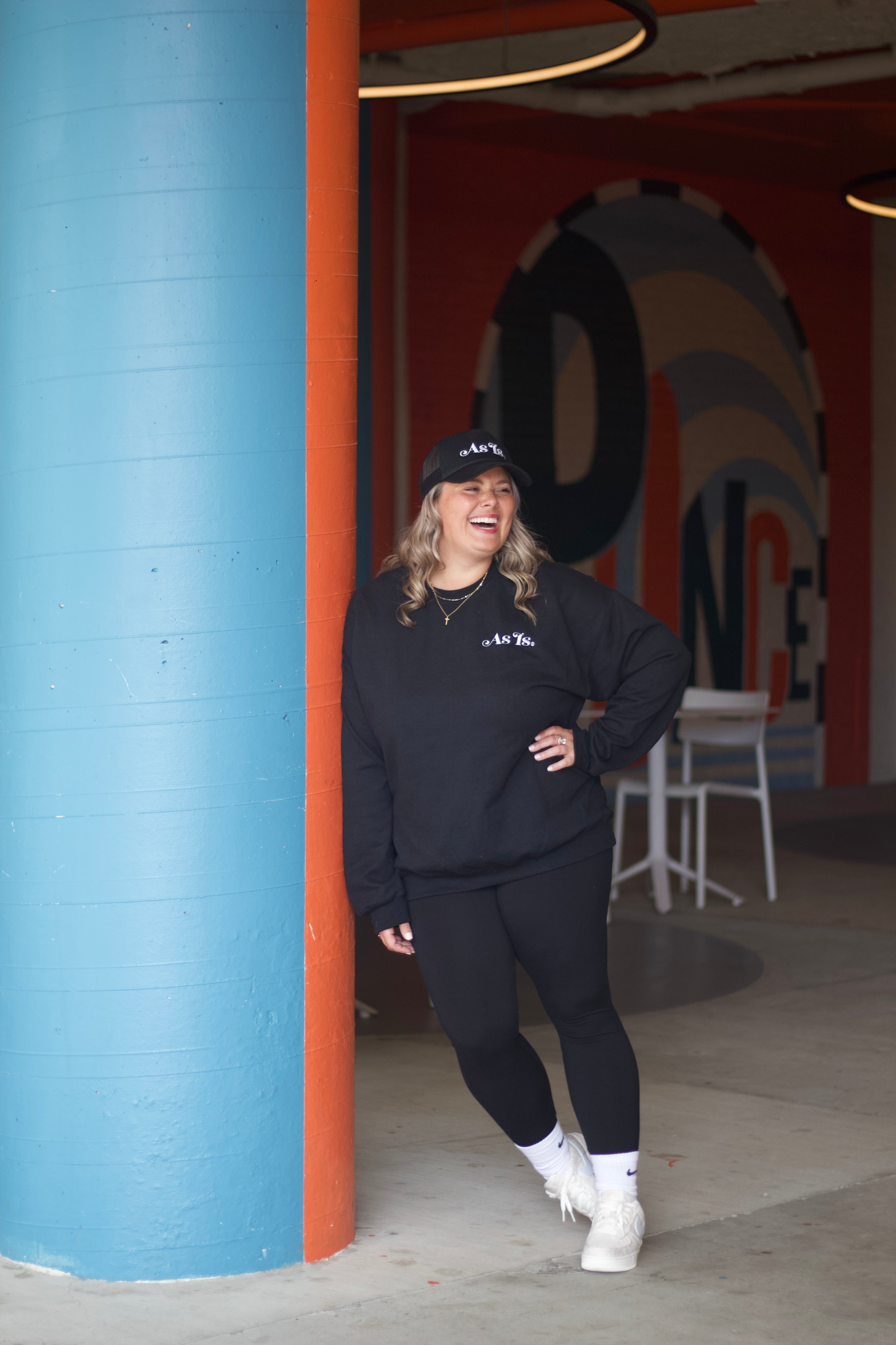 Woman walking through colorful doorway, confident lifestyle portrait