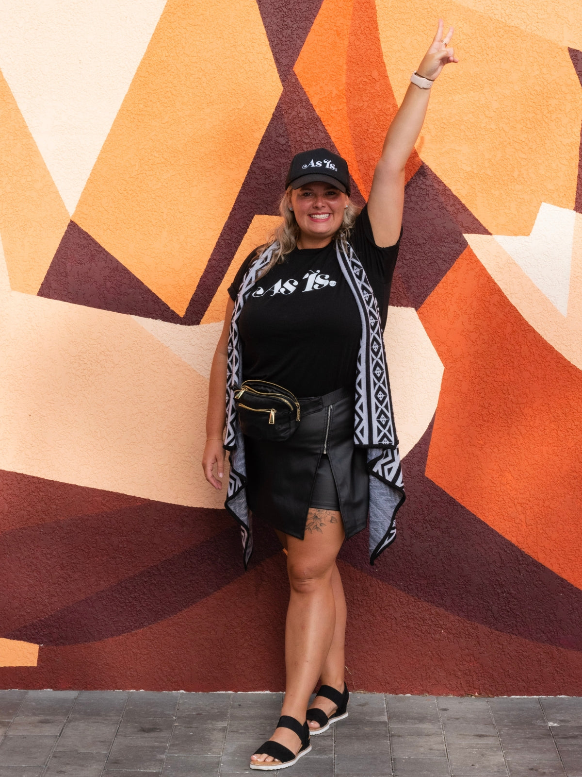 Michaela Fisher standing in front of mural wearing stylish outfit, confidence and self-expression